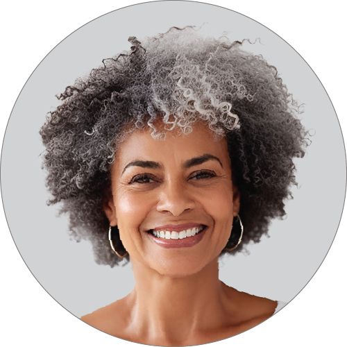 Headshot of a smiling African American female with black and grey hair.