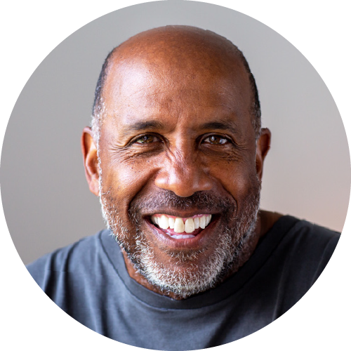 Headshot of Daryl, a smiling, middle aged, African American male.
